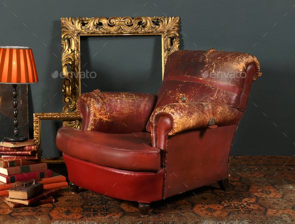 Old leather armchair in retro interior